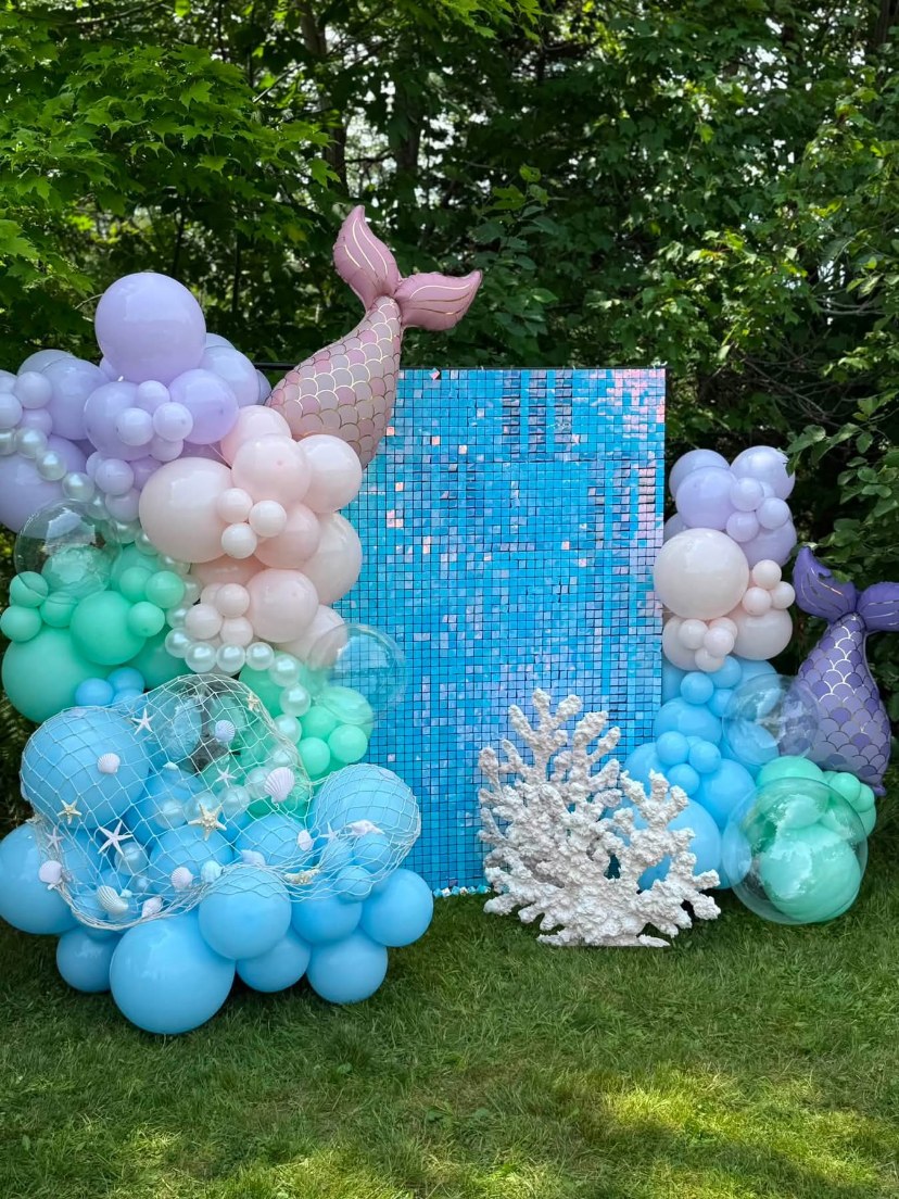 Pastel mermaid balloon display with a turquoise shimmer wall