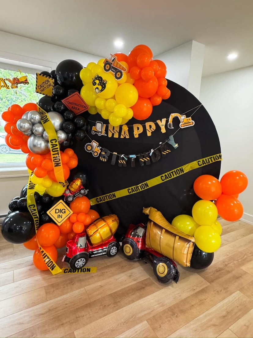 Yellow orange and black construction-themed birthday balloons