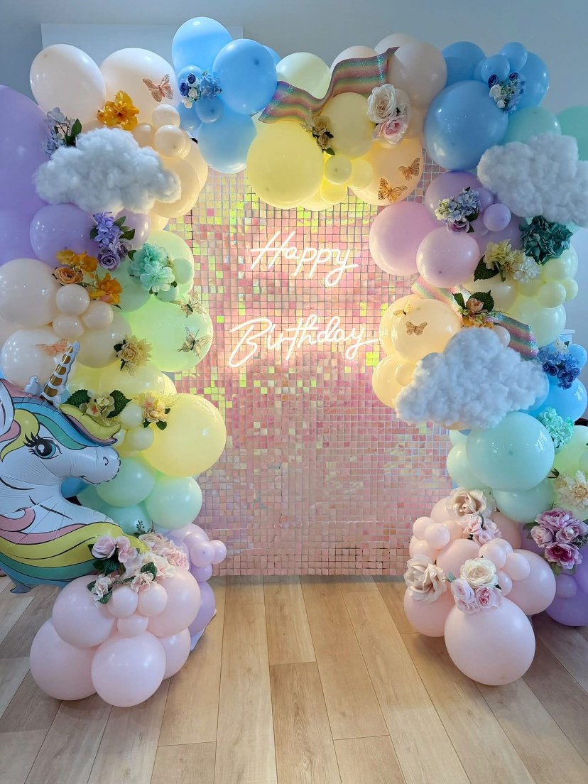 Pastel unicorn balloon display with clouds and an iridescent birthday shimmer wall by Balloons by Billijane